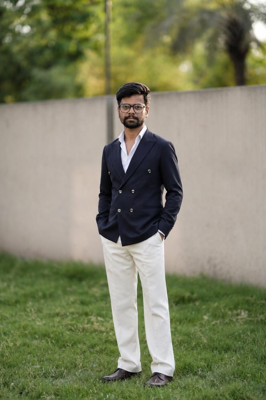 Sharad Nandwana — founder of Witty Productions, in a navy blazer on the lawn